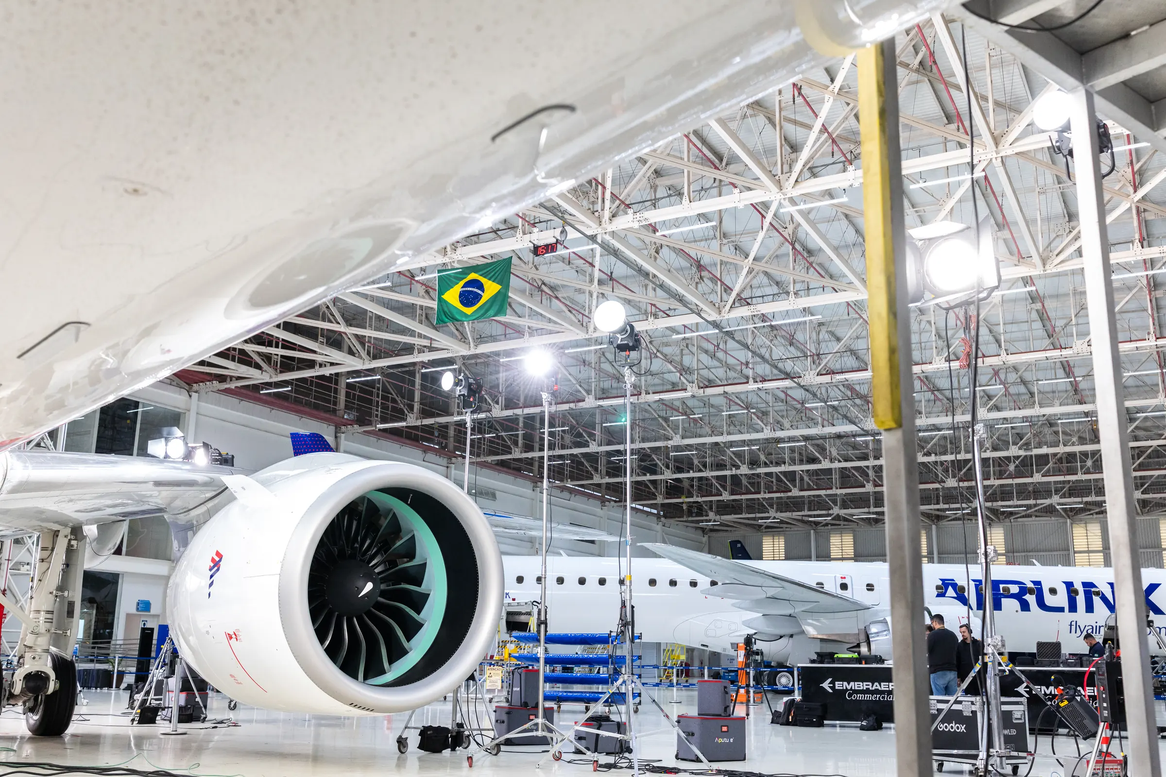 The E2 engine seen from the hangar floor, with the Brazilian flag hanging behind