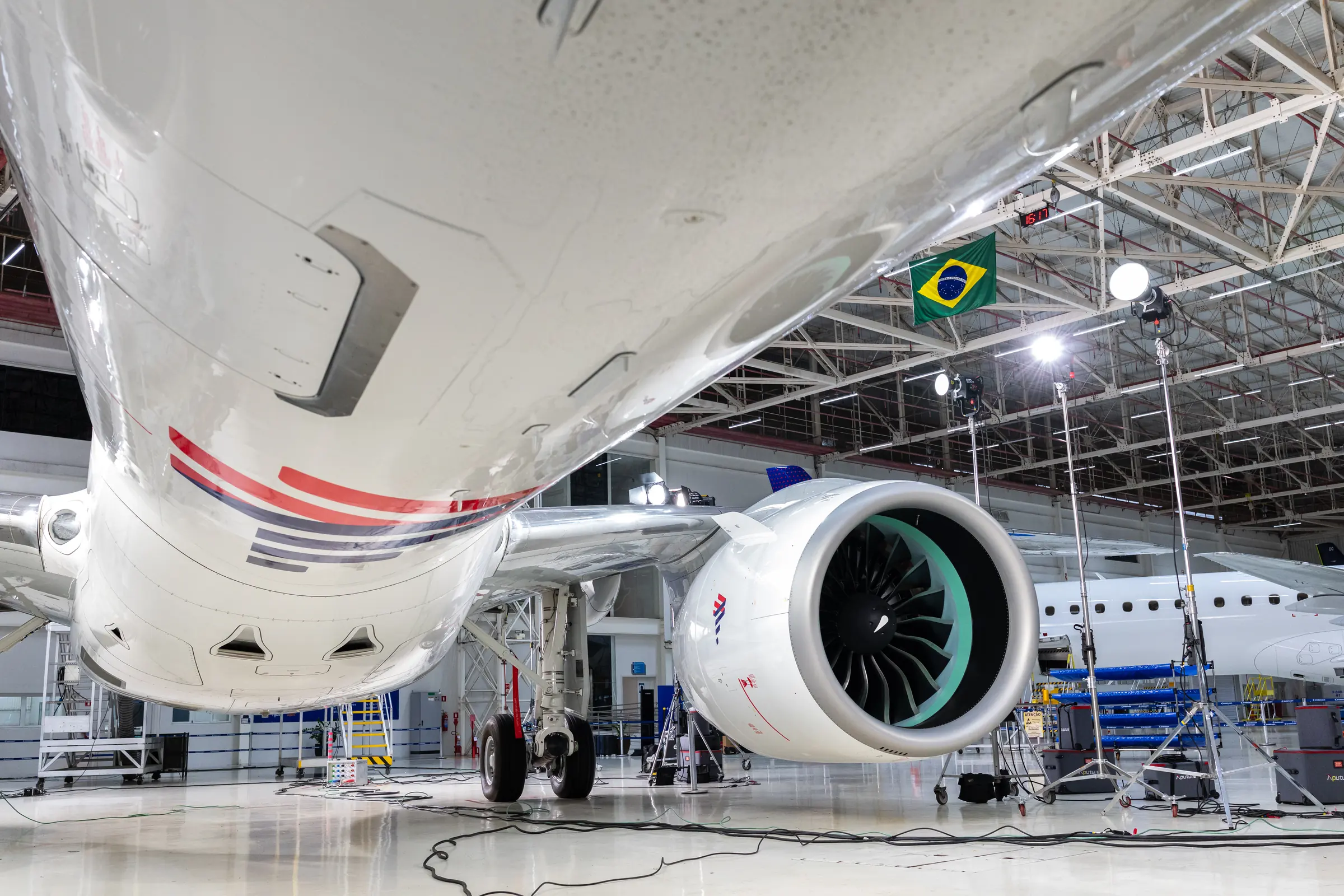 Under the wing, the engine and landing gear framed from ground level