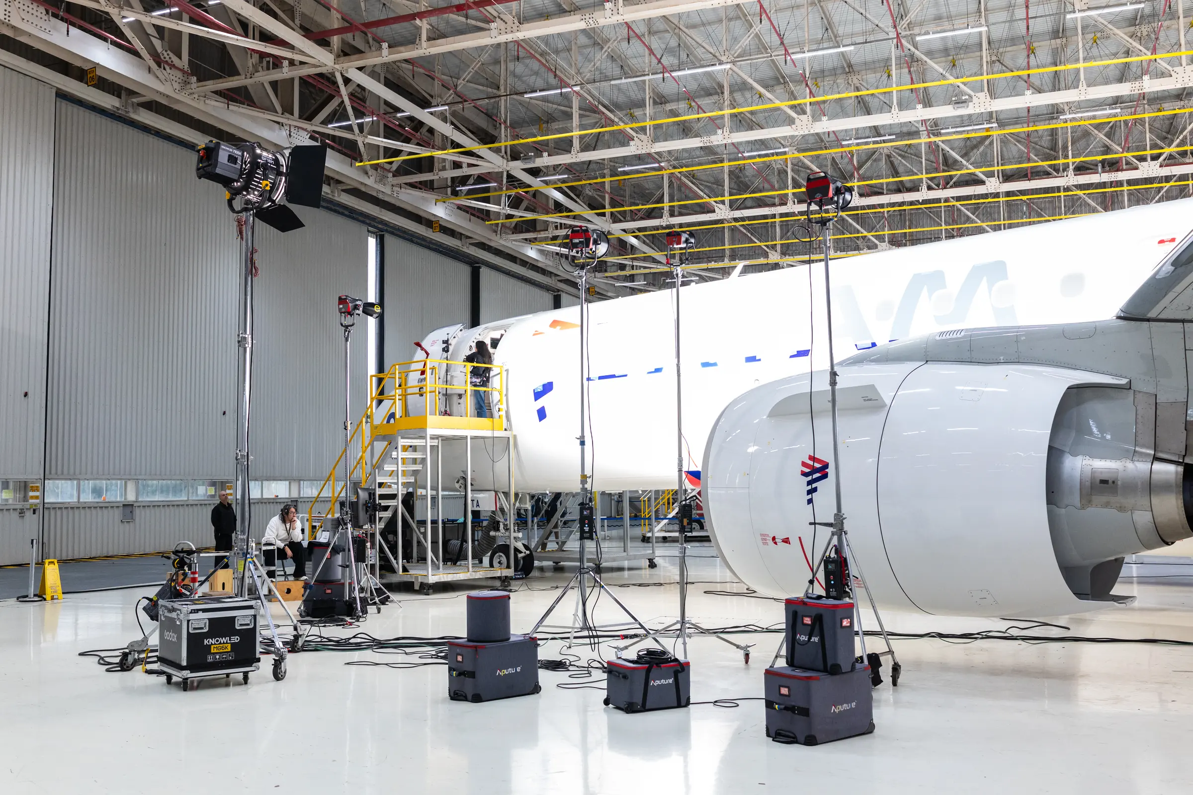 Lighting rigs set up along the side of the aircraft
