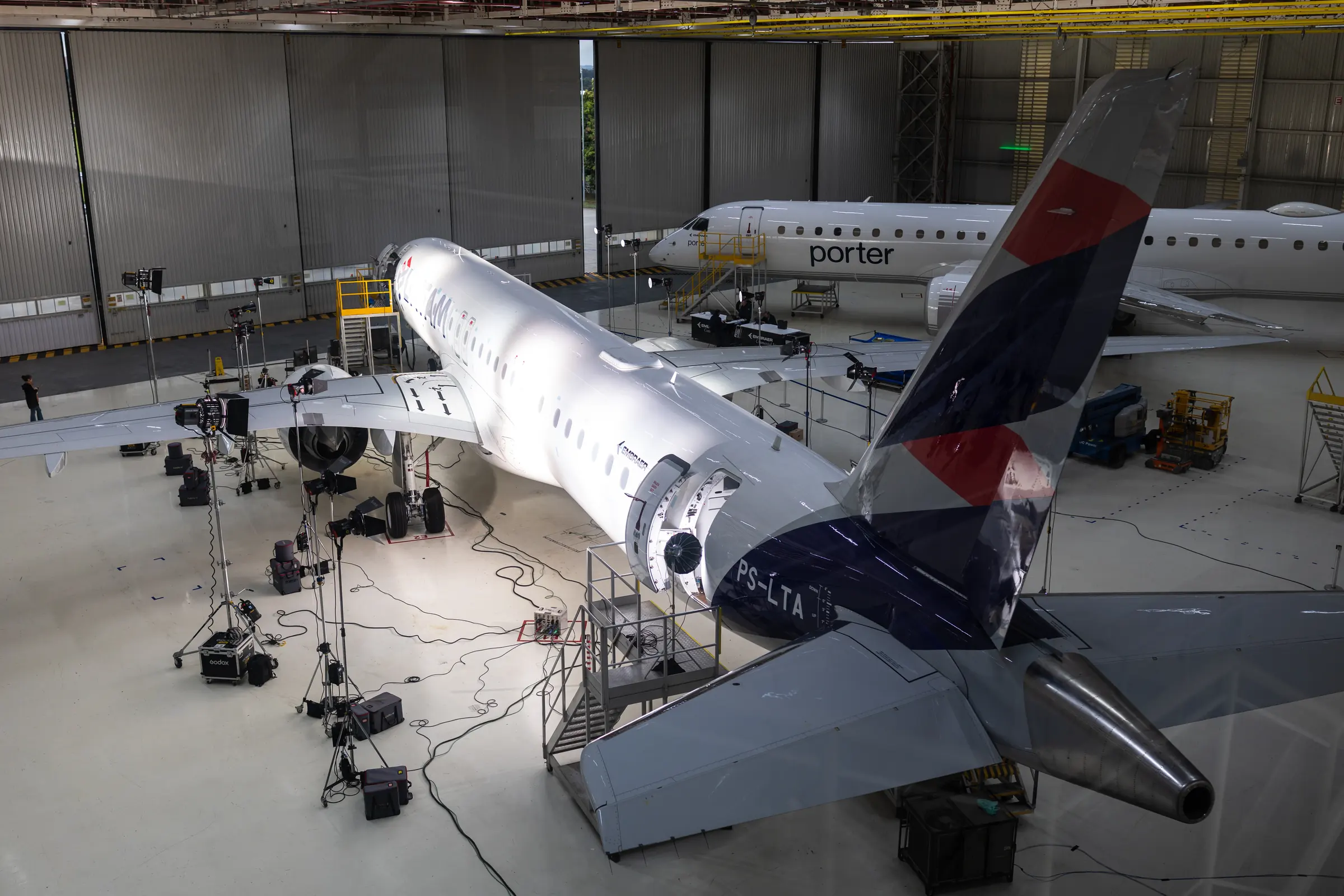 Rear three-quarter view of the aircraft with the LATAM tail and the lighting stands around it